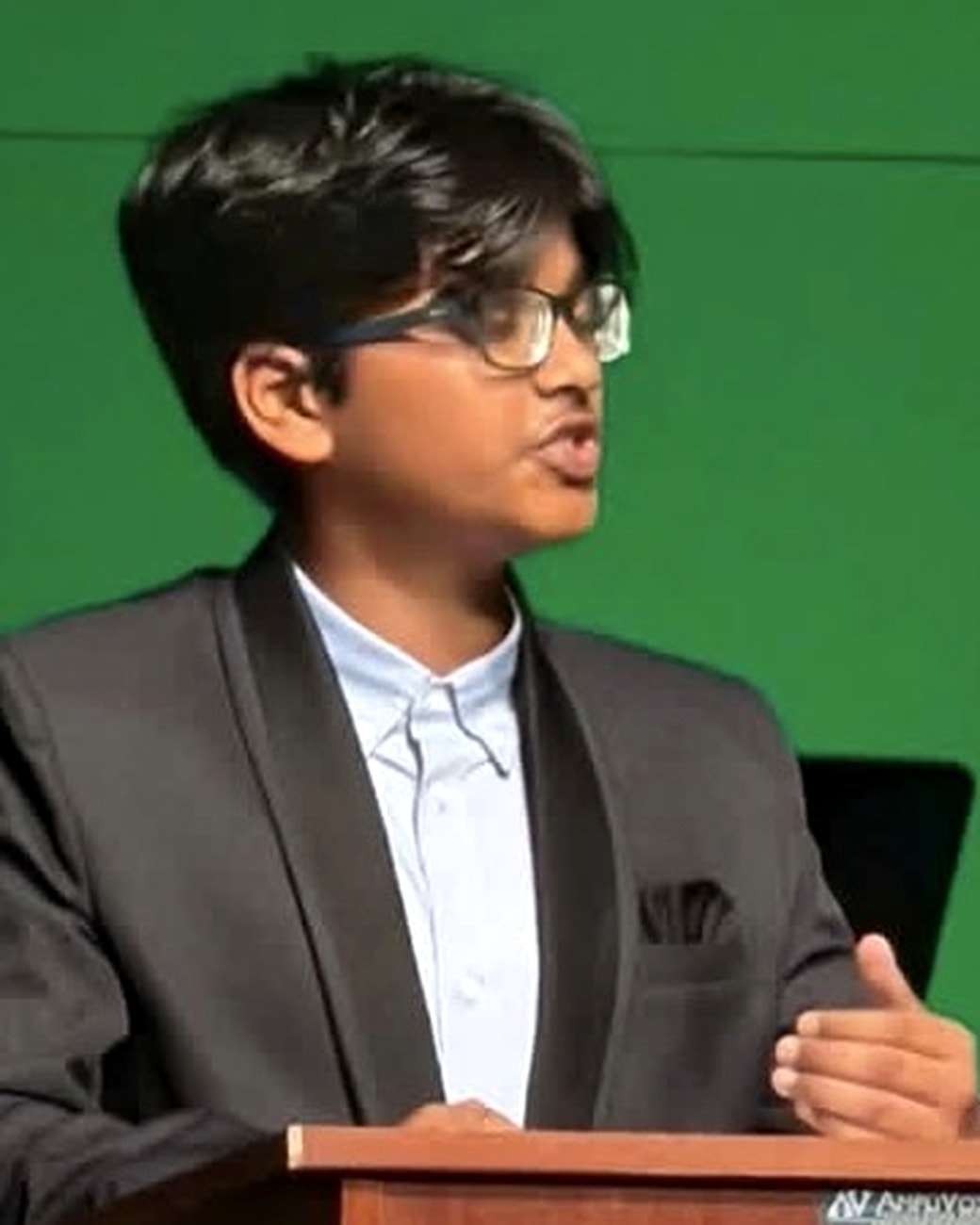 Vikranth speaking at a podium